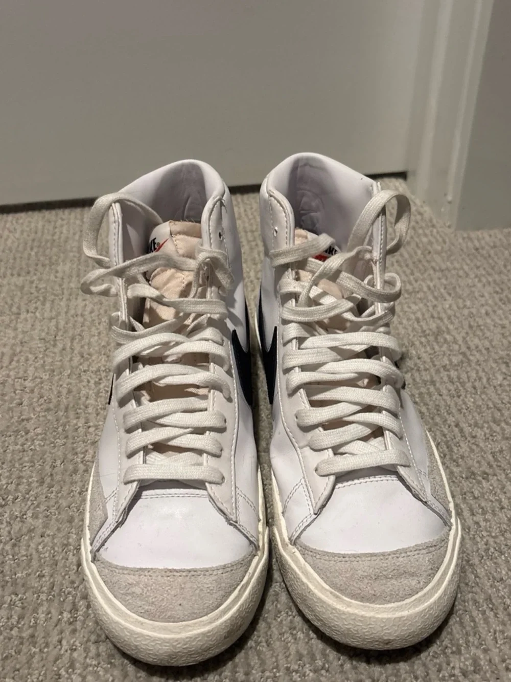 Nike White High-Top Sneakers with Black Swoosh